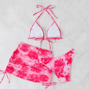 Detailed flat lay of a 3-piece floral bikini set including halter top, bottom and sarong