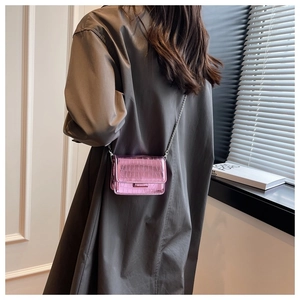 Pink metallic crocodile pattern mini chain bag shown as a stylish crossbody on a model