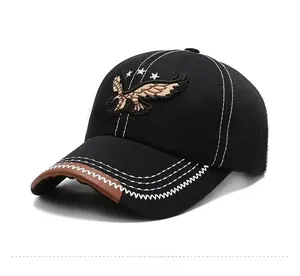 Detail of eagle embroidery and wave-stitched leather brim on a black baseball cap