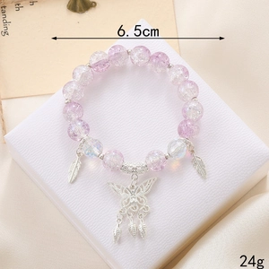 Purple crackle bead bracelet with silver butterfly charm on a white texture stand