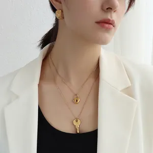 French style 18k gold plated necklace set with key and heart lock pendants on a model