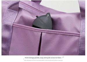 Front storage pocket on purple travel bag with sunglasses for quick item access