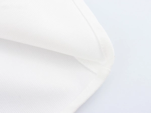Detailed close-up showing the premium corduroy fabric texture and curved seam of white dress