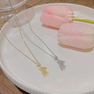Cute teddy bear pendant necklace in gold and silver finish with sparkling star details