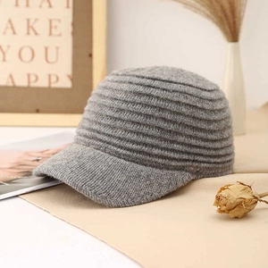 Gray knitted baseball cap for women featuring ribbed wool texture in a minimalist setup
