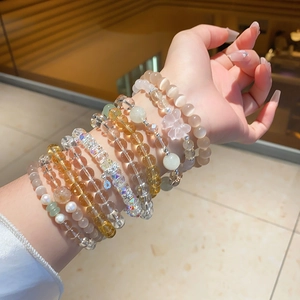 Detail of luxury crystal beaded bracelets with quartz, pearls and delicate metal charms
