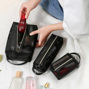 Three-piece black mesh makeup bag set with zipper and handles for travel storage