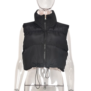 Detail view of the stand-up collar and adjustable drawstring hem on black vest jacket