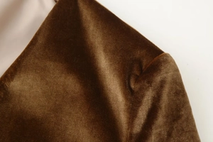 Macro shot of dark brown velvet suit fabric texture and soft luster on the lapel
