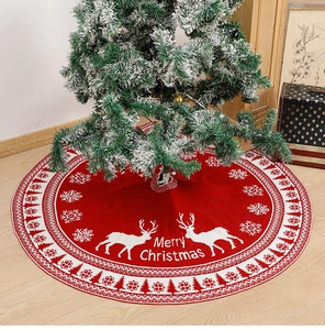 Macro detail of red knitted Christmas tree skirt with white reindeer and snowflake motifs