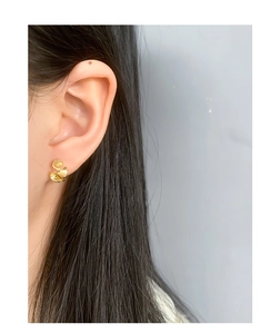 Detail view of gold irregular geometric ruffled earrings on model with matte finish