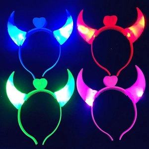 LED devil horn headbands with heart detail in four glowing colors on black background