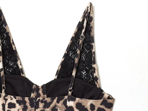 Detail of adjustable straps and black lace neckline on a leopard print maxi dress