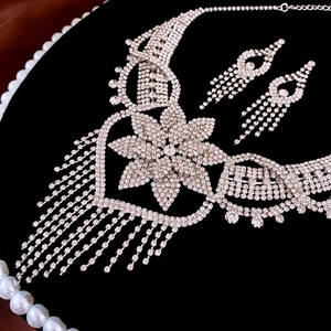 Detail of luxury rhinestone flower necklace and matching tassel earrings set