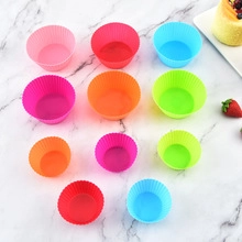 Colorful round ribbed silicone cupcake molds set of 11 on a white marble surface