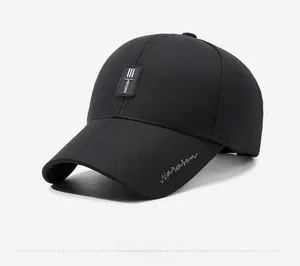 Side view of black cotton baseball cap with Narason rubber label and grey embroidery