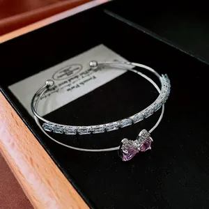 Double-layer silver bangle featuring clear square zircons and a pink bow centerpiece