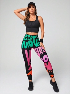 Close-up of vibrant graffiti print yoga leggings with GIRLS MOVE lettering and high waist