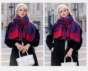 Detail of red and blue cashmere-feel scarf with fringe tassels worn in a street style look