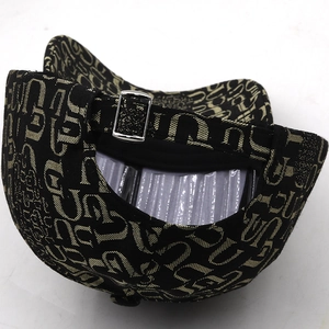 Detail of adjustable silver buckle and black gold jacquard pattern on baseball cap