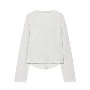 Close-up of light gray knitted V-neck top showing soft texture and asymmetric hemline