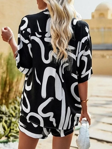 Detail of summer two-piece set featuring abstract black and white print on relaxed fabric