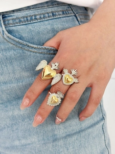 Close-up of gothic sacred heart and wing rings with micro-pave crystals on model's hand
