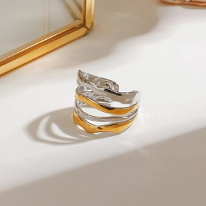Two-tone layered wavy open ring with gold and silver finish and textured metal surface