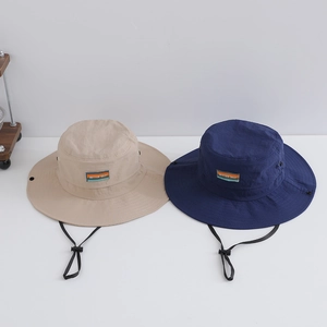 Detail of khaki and navy bucket hats with adjustable drawstrings and side vents