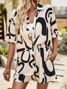 Outdoor shot of women's two-piece set with abstract prints and short-sleeved casual shirt