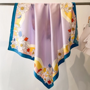 Elegant lavender silk-like square scarf with vibrant floral patterns and geometric borders