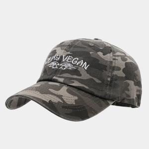 Detail of Very Vegan white embroidery on a washed camouflage baseball cap