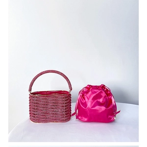 Detail of rose red beaded bucket bag featuring a satin drawstring inner pouch