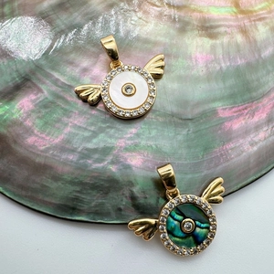 Detail of 18K gold-plated wing charms with white mother of pearl and green abalone shell