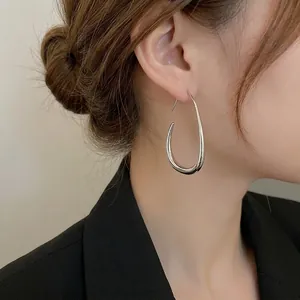 Polished silver large teardrop hoop earrings for women in a minimalist modern style