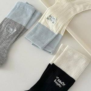 Three pairs of mid-calf knit cotton socks with bow embroidery and ribbed texture cuffs