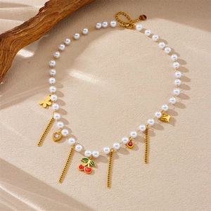 Elegant pearl necklace with gold butterfly, heart and red cherry enamel pendants