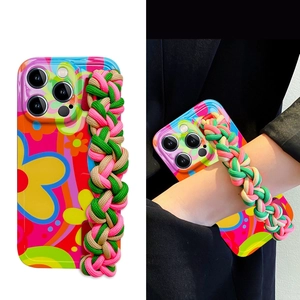Floral iPhone silicone case with a colorful braided wrist strap and crossbody cord