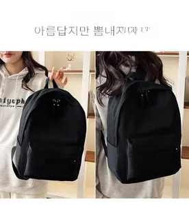 Detail showing the large capacity black nylon backpack with multiple zippered pockets
