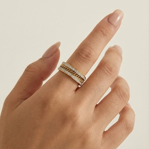 Détail de la bague multicouche dorée avec chaîne et cristaux sur la main