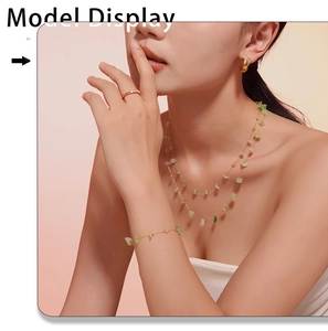 Close-up of model wearing green natural stone necklace and bracelet jewelry set