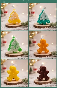 Detail of Christmas tree and gingerbread man scented candles in festive holiday packaging