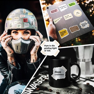 Detail of inspirational vinyl stickers applied on helmet, tablet and mug surfaces