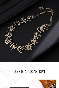 Detail of vintage gold chain necklace with black enamel Celtic knot charms on leather tray