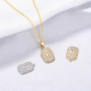 Luxurious gold necklace and T-shaped rectangle zircon pendants on white satin fabric