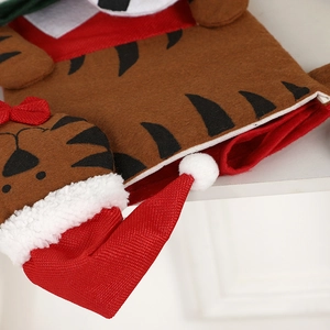 Plush Christmas stocking with tiger head design and red bow on a warm home background