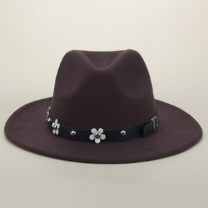Close-up of dark brown wool fedora with white flower petals and silver stud detailing