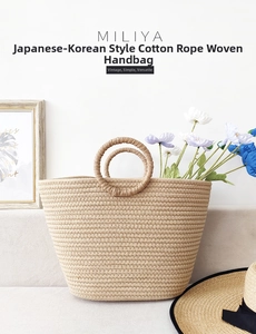 Detailed macro view of the tight spiral cotton rope weave on a khaki beach tote bag