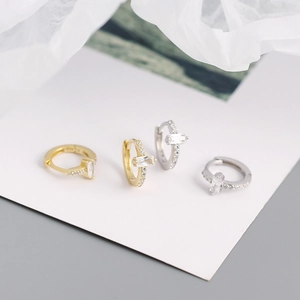 Detail of minimalist S925 silver hoop earrings with rectangular zircon in gold and silver