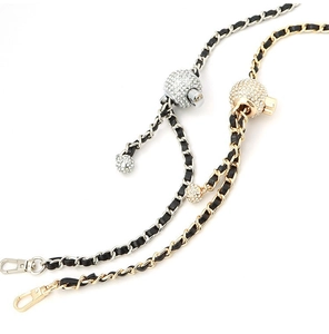 Detail of adjustable metal and leather chain straps with crystal-encrusted gold and silver balls
